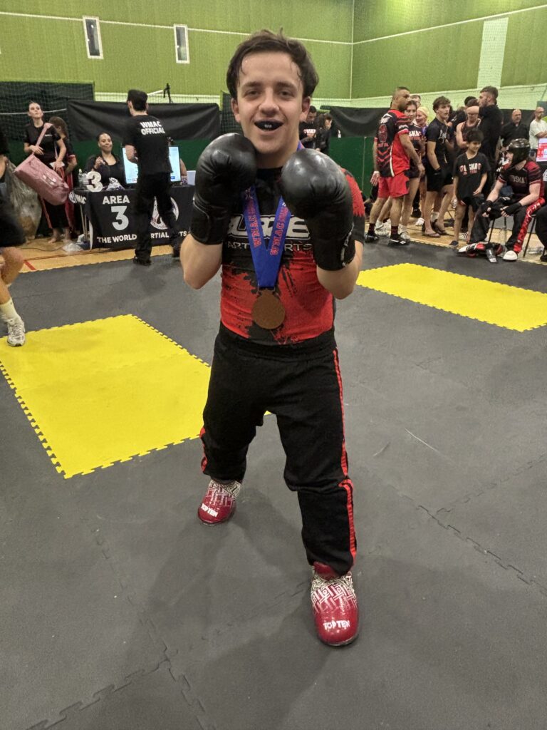 Martial Arts instructor Cyrus after winning a medal in a kickboxing competition with Blaze Martial Arts