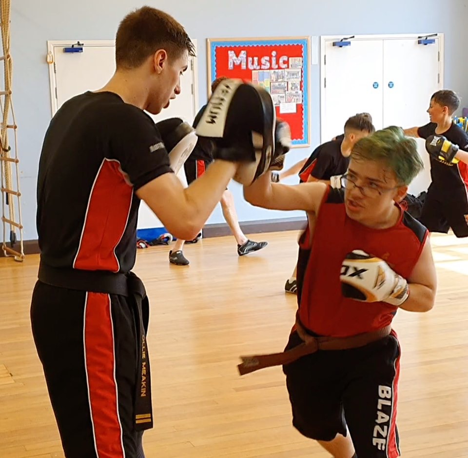 Training in kickboxing in the teen and adult class with Blaze Martial Arts Windsor