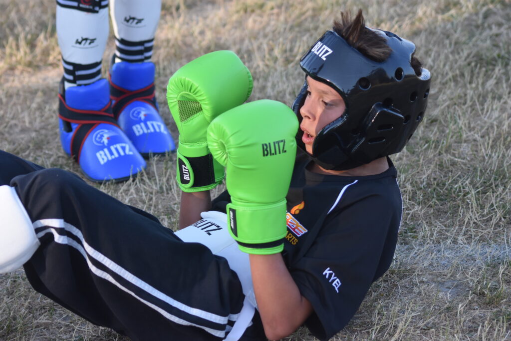 A young child training in the martial arts which is helping him develop confidence